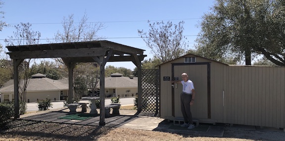 Patio and storage shed that has loaner golf clubs